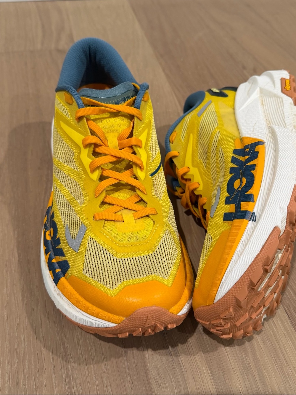 Hoka Yellow Orange Trail Running Shoes with Blue Accents